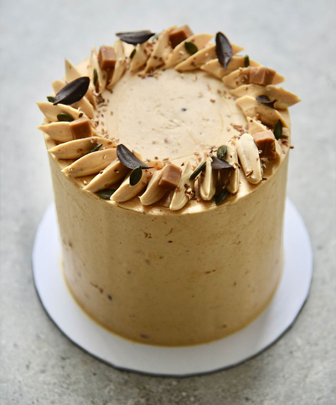 banana brown sugar sponge cake layered with miso caramel and roasted peanut Swiss meringue buttercream